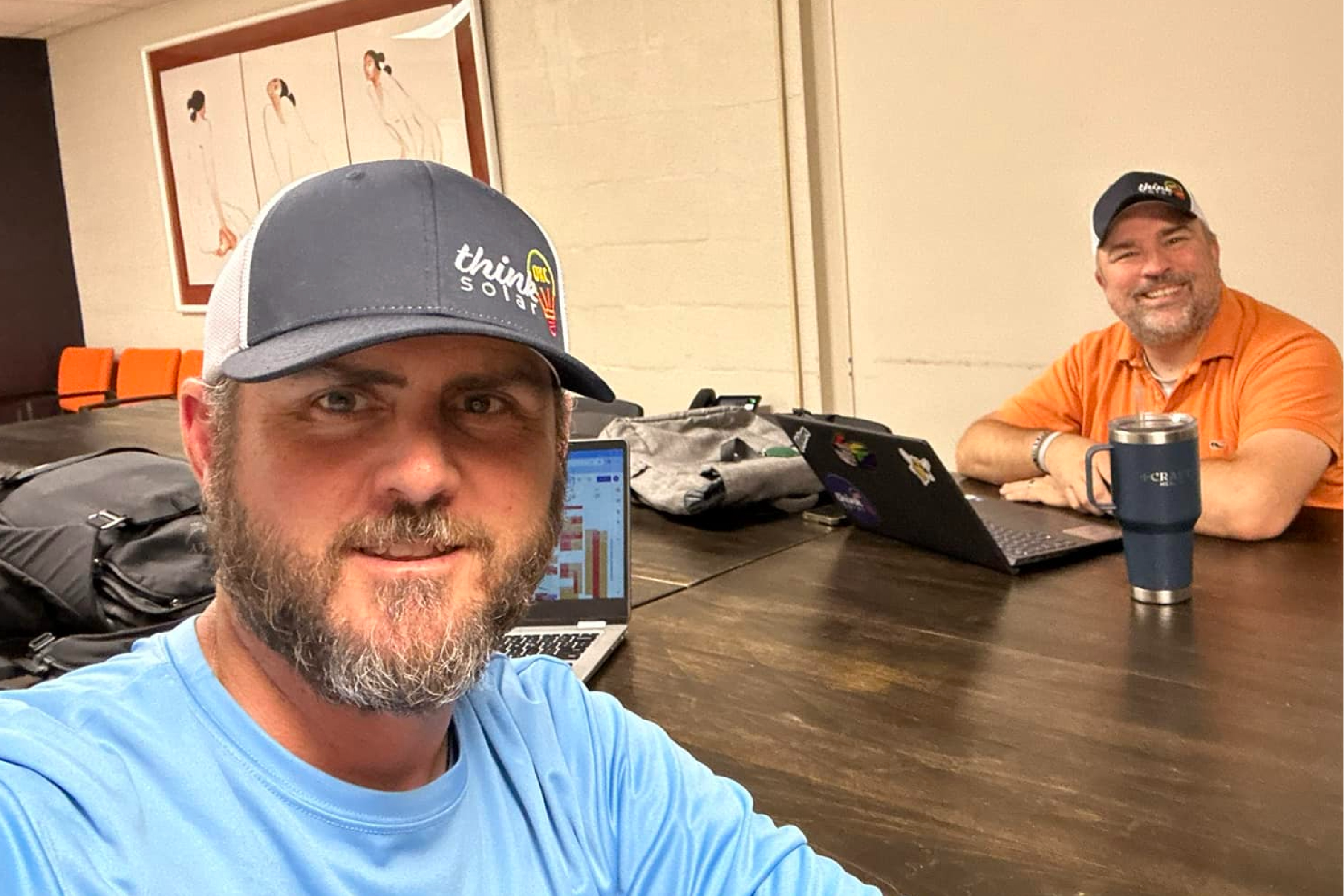 Two think solar OKC employees sitting at a conference table